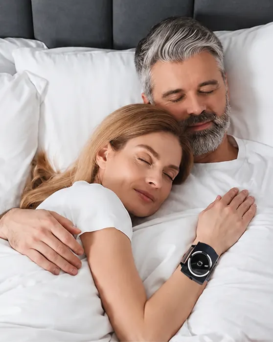 Couple sleeping with the Sleep Connection wristband on the wrist
